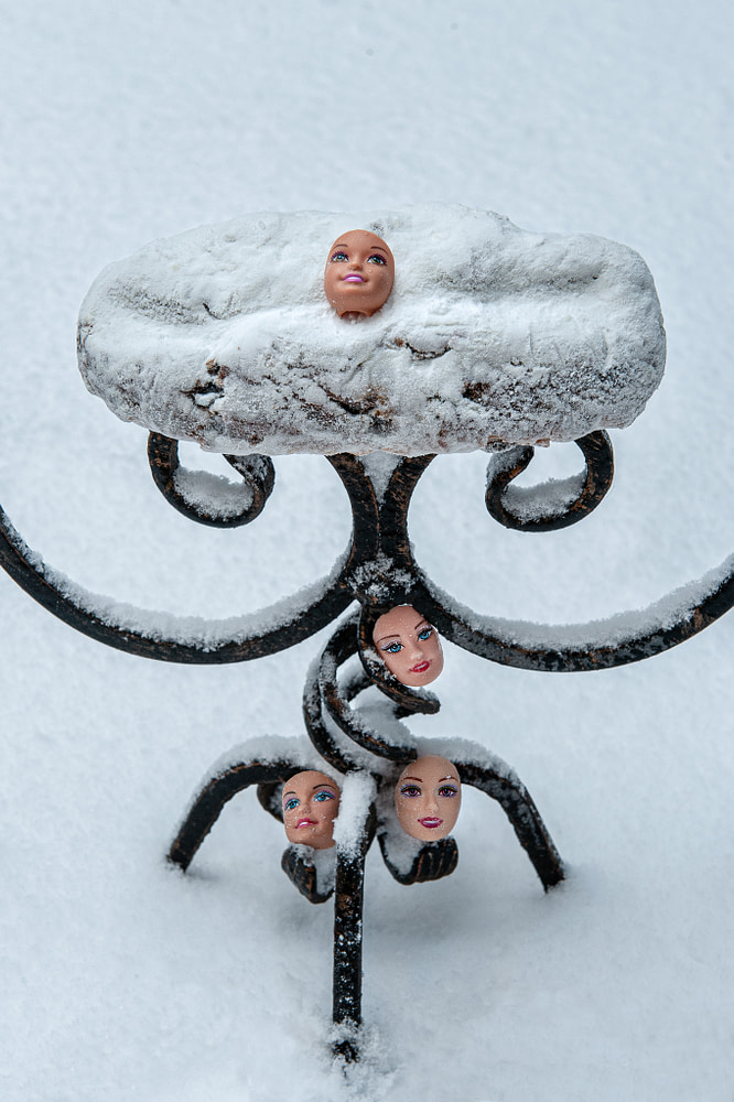 artist photo of Barbie faces in the snow